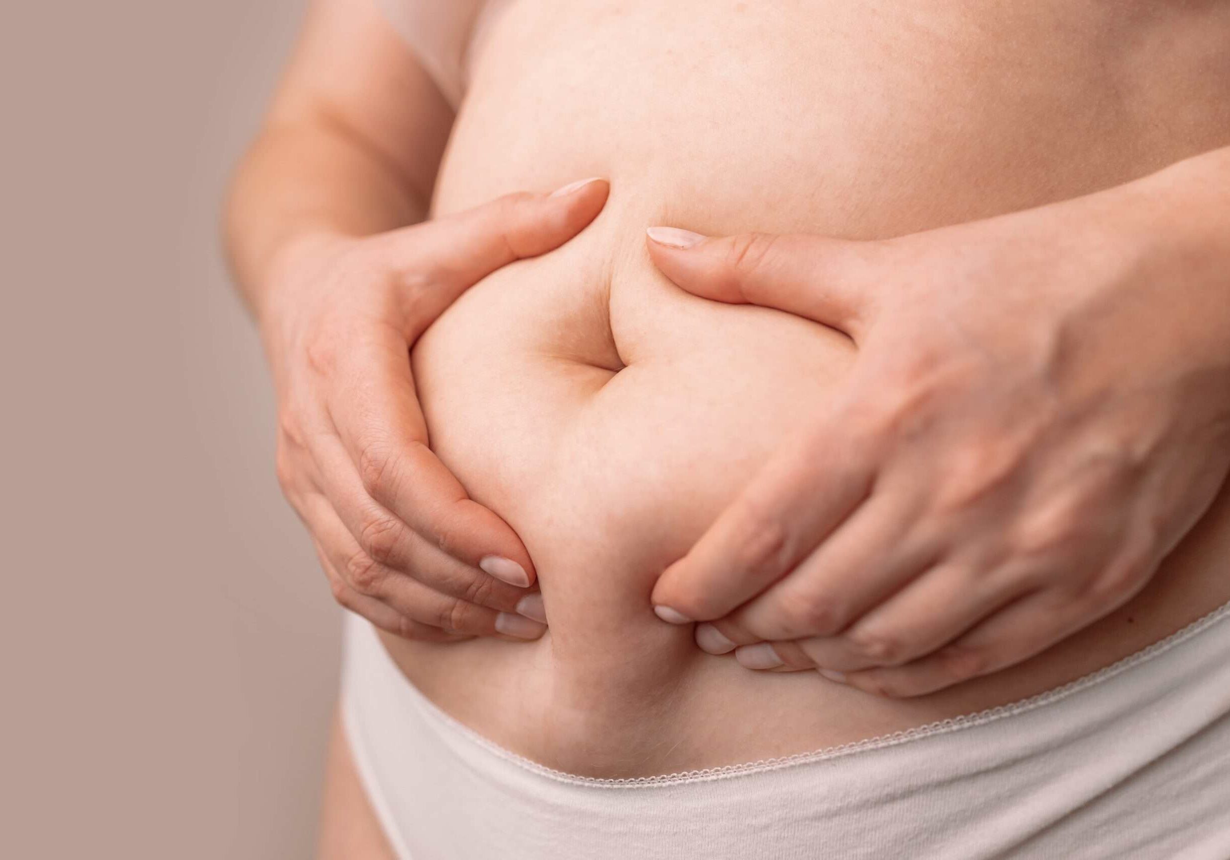 fat-female-belly-woman-holding-skin-to-check-cell-2025-03-11-04-08-21-utc-min